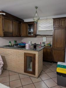 a kitchen with a island in the middle of it at Camera confortevole tra Roma e Ostia in Acilia