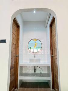 a bathroom with a sink and a mirror at ชรัส รีสอร์ท เกาะล้าน in Ko Larn +65 photos