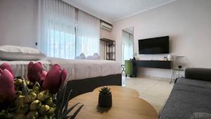 a room with a bed and a table and a couch at Gk Central Studio Xanthi in Xanthi