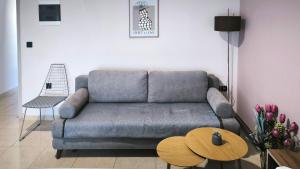 a living room with a couch and a table at Gk Central Studio Xanthi in Xanthi +22 photos