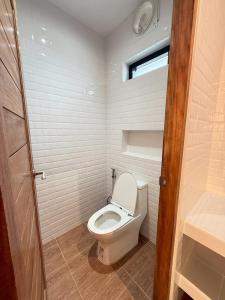 a small bathroom with a toilet and a window at ชรัส รีสอร์ท เกาะล้าน in Ko Larn