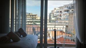 a hotel room with a bed and a large window at Gk Central Studio Xanthi in Xanthi