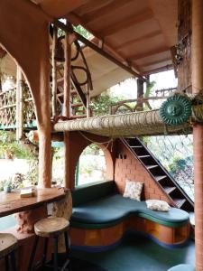 a room with a bench in the middle of a building at Taiga Forest Mountain Tree house in Wayanad