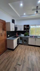 a large kitchen with a sink and a dishwasher at villa baya midoun in Midoun