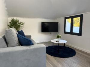 a living room with a couch and a table at Stay Lombinho in Porto da Cruz