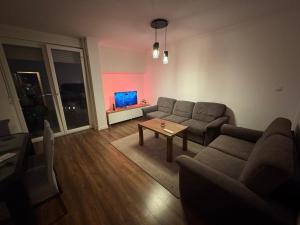 a living room with a couch and a table at Apartman Novak Prijedor in Prijedor