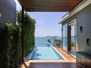 a swimming pool in a house with a view of the ocean at V Villas Phuket - MGallery Collection in Panwa Beach