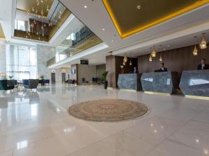 a lobby of a hotel with a marble floor at Swissotel Sarajevo in Sarajevo +147 photos