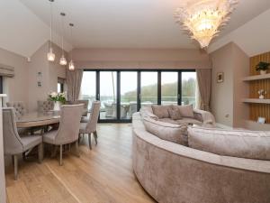 a living room with a large couch and a table at Swing Bridge Cottage in Brandesburton