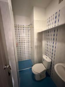 a small bathroom with a toilet and a sink at Alojamiento Rozo in Girón +7 photos