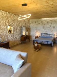 a living room with a bed and a couch at Sarantos Pool Suites in Lakíthra +37 photos