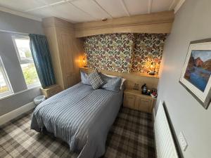 a small bedroom with a bed in a room at Cumbrian Lodge in Seascale