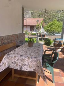 a table with a plant sitting on a patio at POSADA de BUSTIELLO,poblado minero de interés cultural in Mieres +24 photos