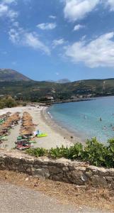 a beach with people swimming in the water at Helios-Selene Villa in Lévktron