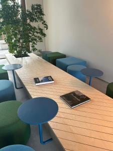 a wooden table with chairs and a book on it at Snow Hotel Druskininkai in Druskininkai