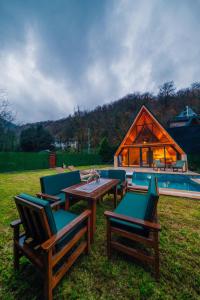 a group of chairs and tables in front of a house at Green date bungalow in Sapanca
