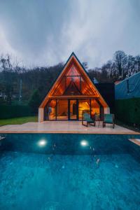 a large wooden house with a pool in front of it at Green date bungalow in Sapanca