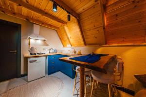 a kitchen with blue cabinets and a wooden ceiling at Green date bungalow in Sapanca