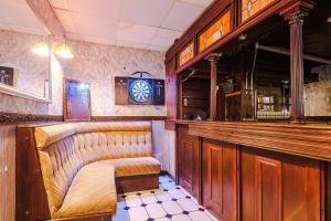 a bar with a bench and a clock on the wall at The Sonora Park Contactless Hotel by BET stays in Blackpool
