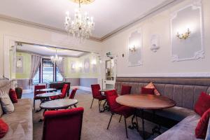 a restaurant with tables and chairs and a chandelier at The Sonora Park Contactless Hotel by BET stays in Blackpool