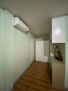 a room with white walls and a wooden floor at Tiny Home fronting Alburquerque Church in Alburquerque