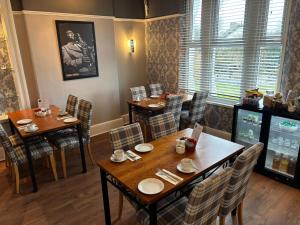 a dining room with tables and chairs in a restaurant at Cumbrian Lodge in Seascale