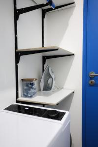 a room with a white counter with black shelves at Le Quai Verrière in Belfort
