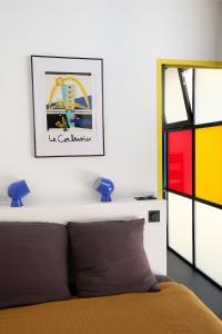 a bedroom with a bed and a picture on the wall at Le Quai Verrière in Belfort +11 photos