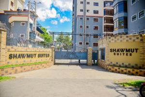 a gate to a building with shawmut suites on it at Savana Abode-Nakuru CBD in Nakuru