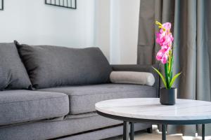 a living room with a couch and a table with a flower at Azure Edge - Seafront View - Beach Stay in Tigaki +19 photos
