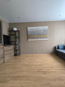 a living room with a couch and a television at Apartment GLORIA in Narva-Jõesuu