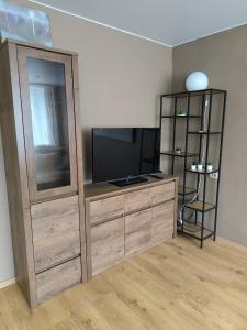 a room with a entertainment center with a flat screen tv at Apartment GLORIA in Narva-Jõesuu