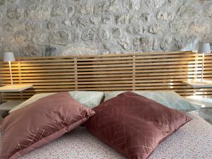 two pillows sitting on a bed in a bedroom at Appartamento Scaligeri in Venzone