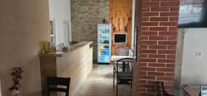 a kitchen with a bar and a brick wall at Hotel Poli in Blagoevgrad +30 photos