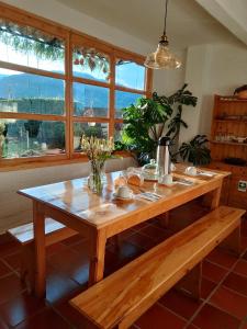 a wooden table in a room with a large window at Villa Luz Hotel in Silvia