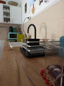 a kitchen with a sink and a counter with dishes at Kékfestő Vendégház in Bükkszentkereszt