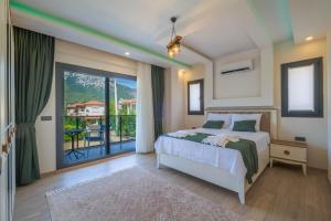 a bedroom with a bed and a balcony at Villa Huzur in Fethiye +63 photos