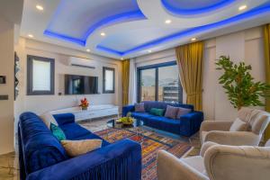 a living room with blue furniture and a blue ceiling at Villa Huzur in Fethiye