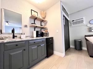 a kitchen with a sink and a mirror in a room at Set on peaceful 5 acres, 5 min from town, Private Building, Level 2 EV Charger in Bloomington