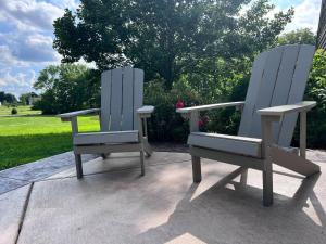 two chairs sitting next to each other on a patio at Set on peaceful 5 acres, 5 min from town, Private Building, Level 2 EV Charger in Bloomington +25 photos
