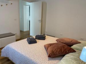 a bedroom with a bed with two pillows on it at Appartamento Scaligeri in Venzone
