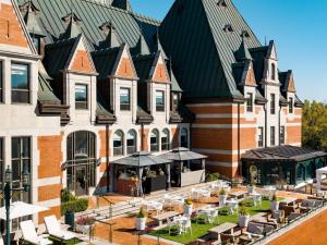 a building with tables and chairs in front of it at Fairmont Le Chateau Frontenac in Quebec City