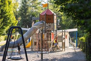 a playground with a slide in a park at camping Le moulin in Patornay