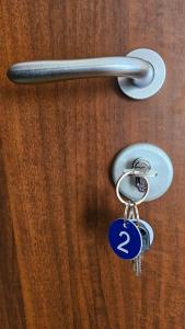 a pair of keys hanging from a door handle at AURY HOUSE -HistoricCenter- in Cremona