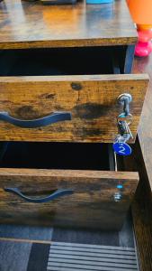 a wooden drawer with a handle and a chain at AURY HOUSE -HistoricCenter- in Cremona