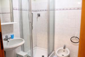 a bathroom with a shower and a toilet and a sink at La casa del Darda 3 in Ancona +13 photos
