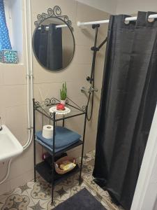 a bathroom with a shower with a black shower curtain at Kékfestő Vendégház in Bükkszentkereszt +23 photos