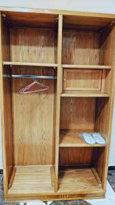 a wooden closet with wooden shelves in a room at GRAND MuseuM HoteL in Cairo