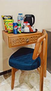 a wooden desk with a blue chair and a table with snacks at GRAND MuseuM HoteL in Cairo +77 photos