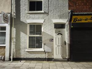 a brick building with a white door and windows at St Peters Avenue in Cleethorpes